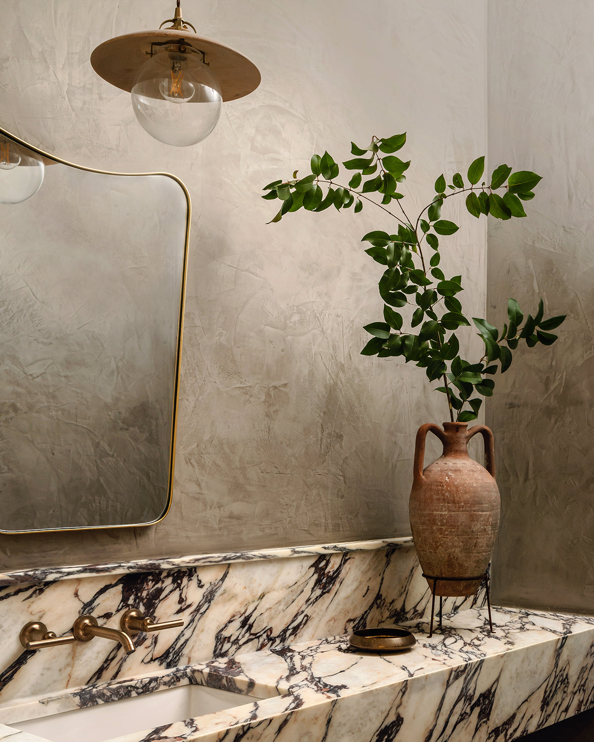 Pendant light with large clear glass globe and decorative wooden clear maple shade hanging over bathroom sink. Made by Lostine in Philadelphia. Simple interior design, made in the USA. Warm American Modern Design