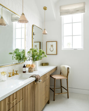 Classic cone pendants with hand-stitched decorative leather shade and glass diffuser hanging over bathroom sink