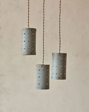 Charming leather pendant light with blue handstitched shade and brass accents