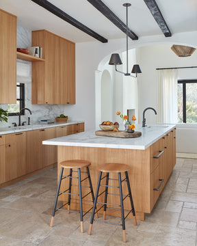 LOSTINE NATURAL GORDON STOOL - IRON BASE in modern kitchen at kitchen island- Classic ladder metal base stool with wooden seat and feet, workshop stool. Counter and bar height. Made by Lostine in Philadelphia. Simple interior design, made in the USA. Warm American Modern Design